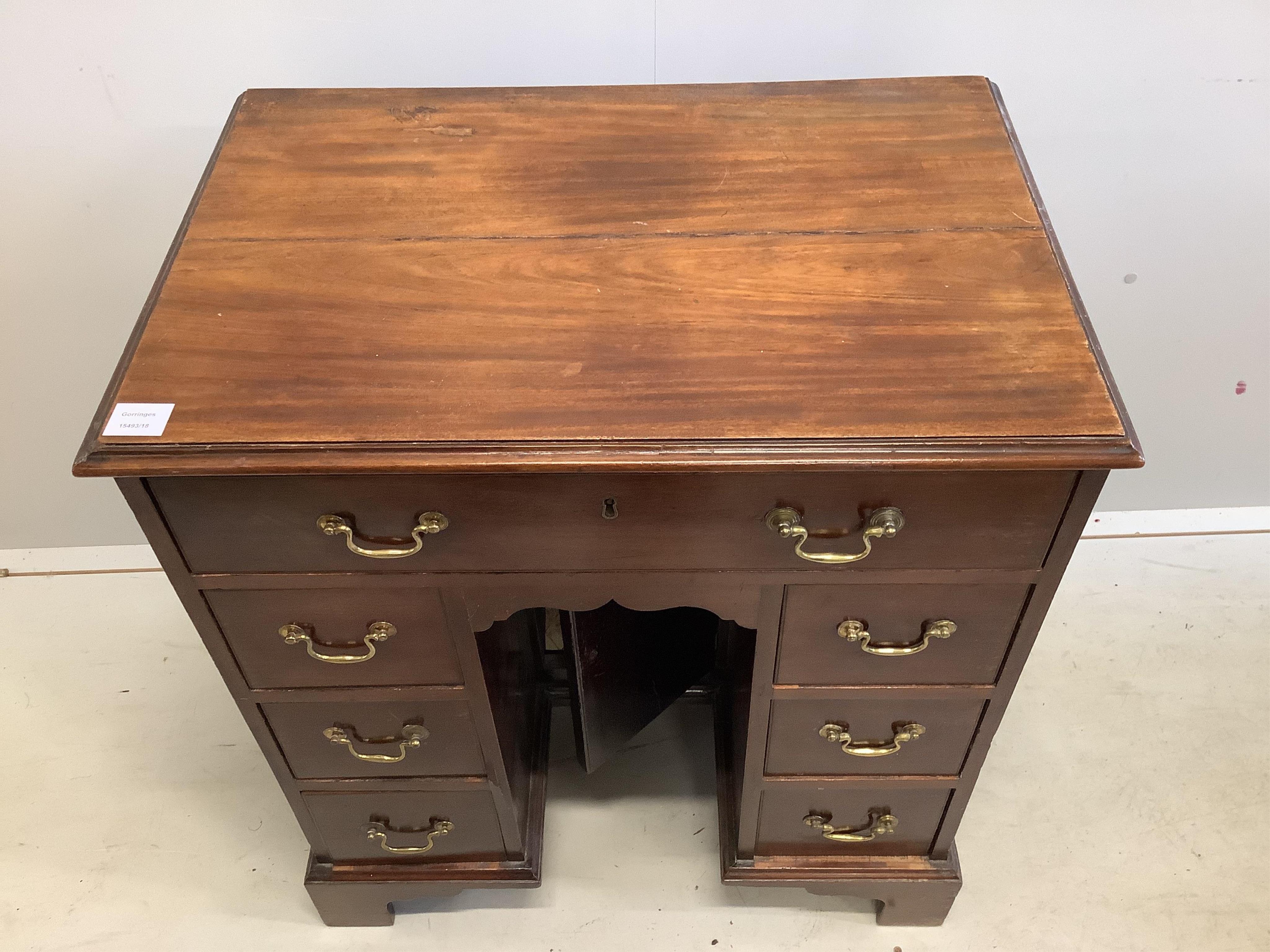 A George III mahogany kneehole desk, width 71cm, depth 48cm, height 80cm. Condition - fair to good